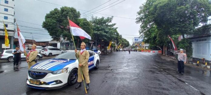 Polisi mengajak pengendara di Banyuwangi menghormat di momen peringatan detik-detik Proklamasi, Kamis (1/8/2023). (foto/udi)