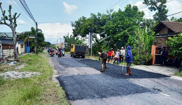 Petugas Dinas PU Cipta Karya dan Penataan Ruang (PU CKPR) Banyuwangi mengerjakan perbaikan jalan, Senin (1/4/2024). (Foto/ist)